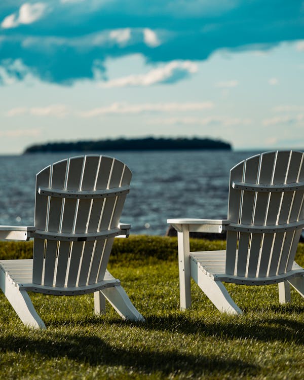 Poly Adirondack chairs by a peaceful lake
