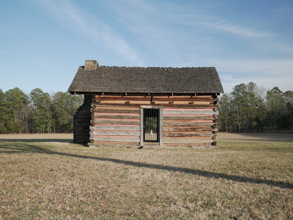 Wooden storage shed in a sunlit field